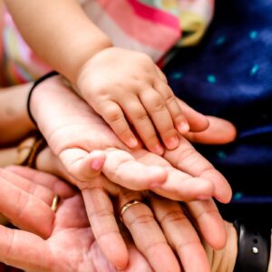 person wearing black watch holding babys hand